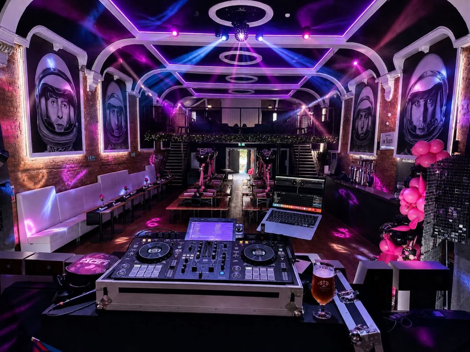 The Lathom Hall with purple lighting, Beatles artwork and a DJ setup